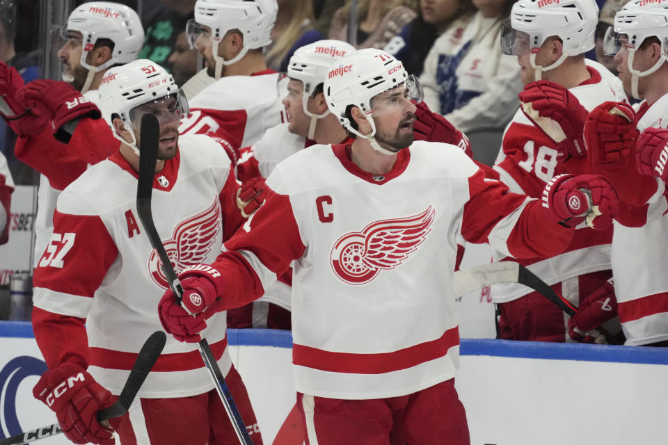 Detroit Red Wings center Dylan Larkin (71) celebrates after his goal against the Toronto Maple Leafs with teammates during second-period NHL hockey game action in Toronto, Sunday, Jan. 14, 2024. (Frank Gunn/The Canadian Press via AP)