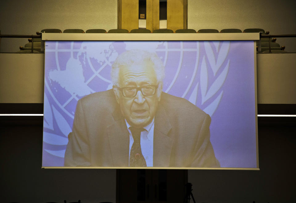 U.N. mediator Lakhdar Brahimi is pictured on a giant screen as his press briefing is fed live to the interim press working space at the United Nations headquarters in Geneva, Switzerland, Tuesday, Jan. 28, 2014. Negotiations between Syrian negotiators broke off earlier than planned Tuesday amid mutual accusations and the government's anger over the resumption of U.S. aid to the opposition. (AP Photo/Anja Niedringhaus)