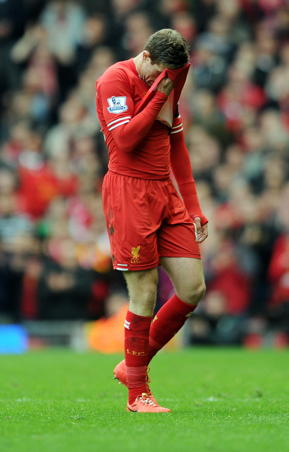 Liverpool's Jordan Henderson leaves the field after being shown a red card by referee Mark Clattenburg during their English Premier League soccer match at Anfield in Liverpool, England, Sunday April. 13, 2014. (AP Photo/Clint Hughes)