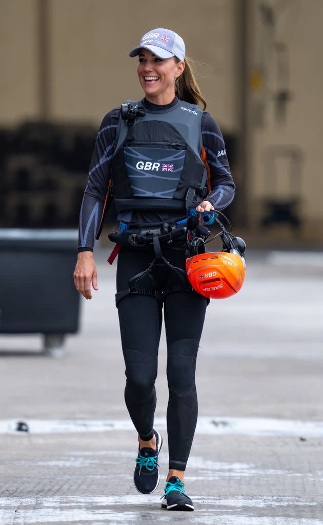 Kate walks through the Technical Base in a Great Britain SailGP Team wetsuit. (Photo: Bob Martin for SailGPBob Martin for SailGP)