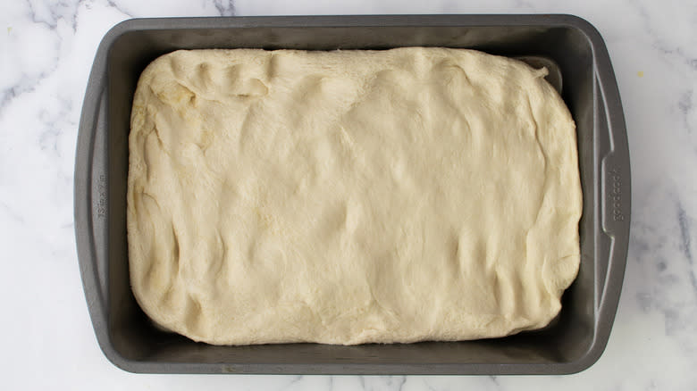 dough pressed into baking dish