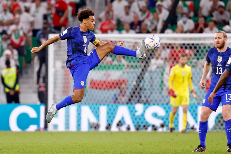 USMNT captain Tyler Adams kicks the ball against Iran during the second half of Tuesday's game.