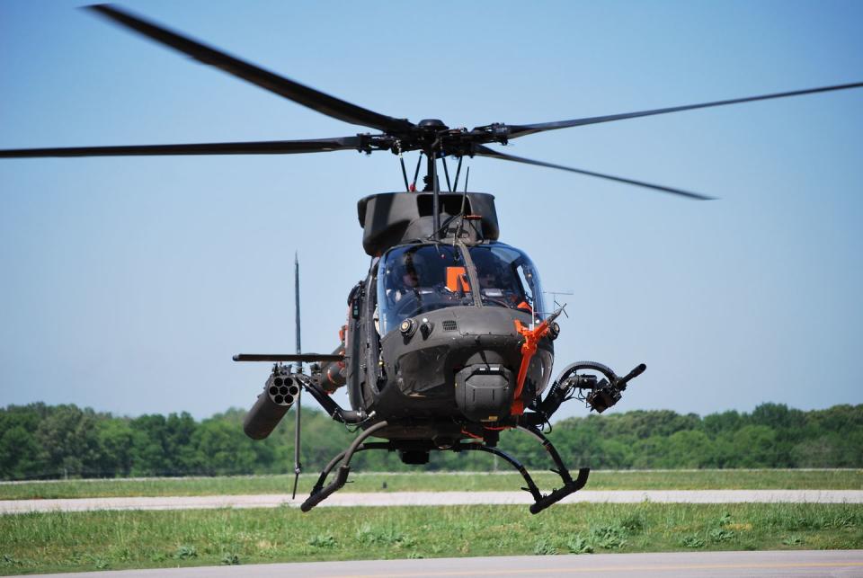 a helicopter flying over a runway