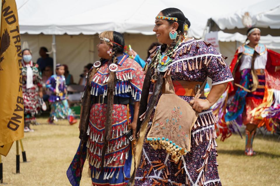 Victoria Alfonseca, right, the head dancer at the 2022 Kchi Wiikwedong Anishinaabek Pow Wow in Traverse City, smiles as she dances alongside Leilani Defoe.