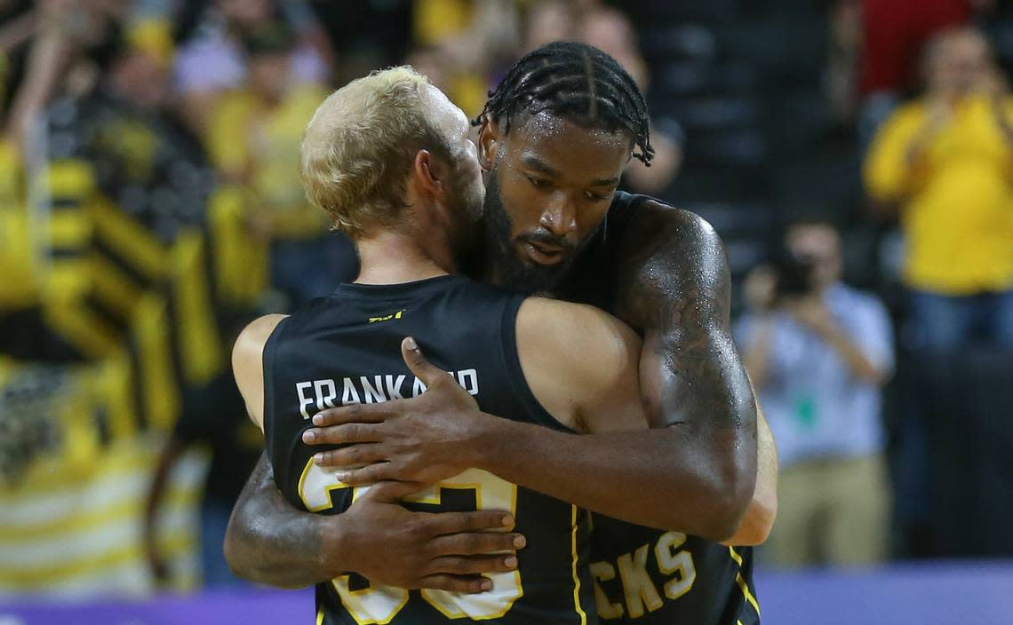The Aftershocks’ Conner Frankamp, left, and Rashard Kelly embrace after defeating the Air Raiders, a team of Texas Tech Alum, during the second round of The Basketball Tournament on Saturday night.
