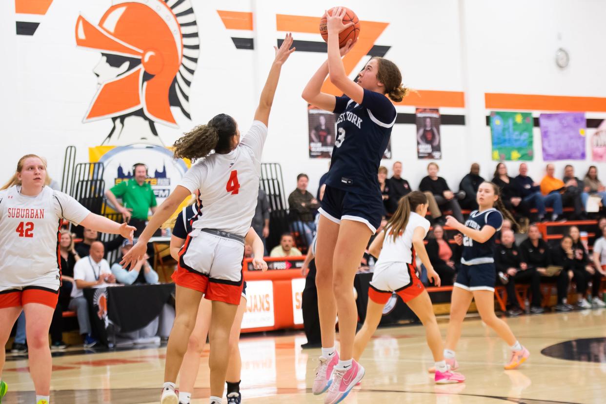 West York's Faith Walker shoots over York Suburban's Janay Rissmiller (4) in a District 3 playoff game. Both players were named to the all-state team.