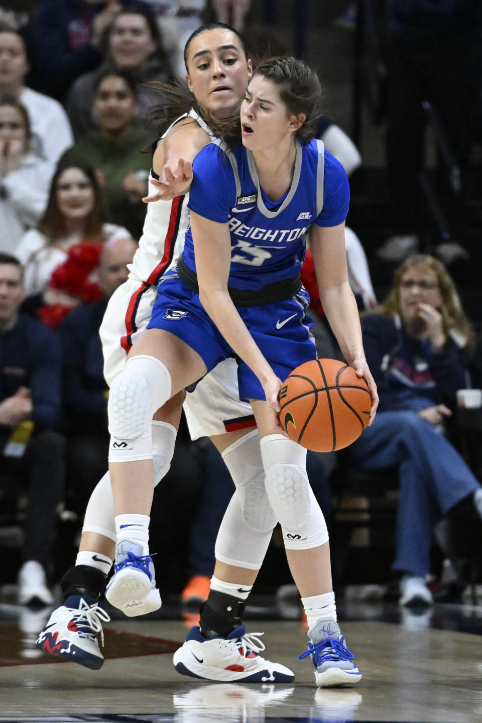 Creighton's Lauren Jensen, front looks to pass under pressure from UConn's Nika Muhl during the second half of an NCAA college basketball game Wednesday, Feb. 15, 2023, in Storrs, Conn. (AP Photo/Jessica Hill)