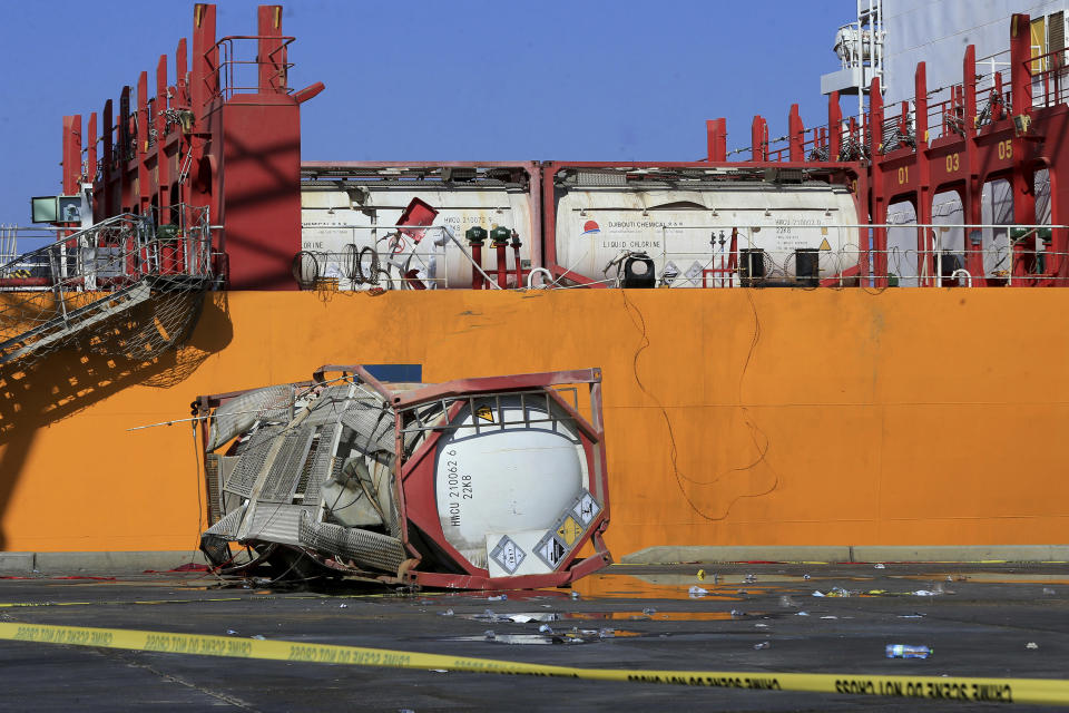 A chlorine tank lies on the ground at the site of a toxic gas explosion in Jordan's Red Sea port of Aqaba, Tuesday, June 28, 2022. A crane loading chlorine tanks onto a ship on Monday dropped one of them, causing an explosion of toxic yellow smoke that killed over a dozen people and sickened some 250, authorities said. (AP Photo/Raad Adayleh)