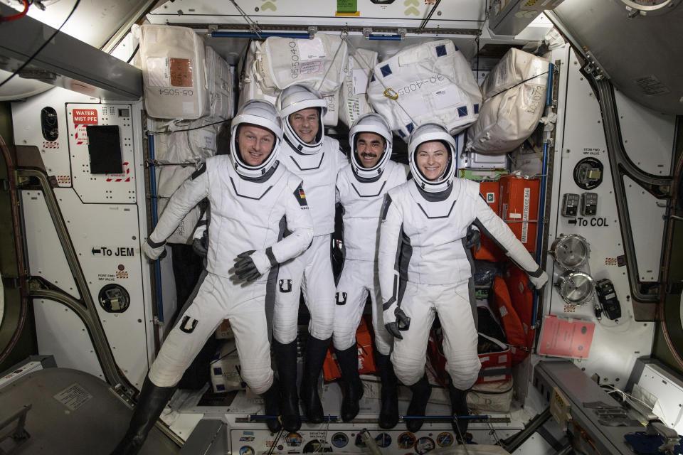 In this photo made available by NASA, four commercial crew astronauts, from left, European Space Agency astronaut Matthias Maurer and NASA astronauts Tom Marshburn, Raja Chari and Kayla Barron pose for a photo in their Dragon spacesuits during a fit check aboard the International Space Station's Harmony module on April 21, 2022. SpaceX brought the four astronauts home with a splashdown in the Gulf of Mexico early Friday, May 6, capping the busiest month yet for Elon Musk’s taxi service. (NASA via AP)