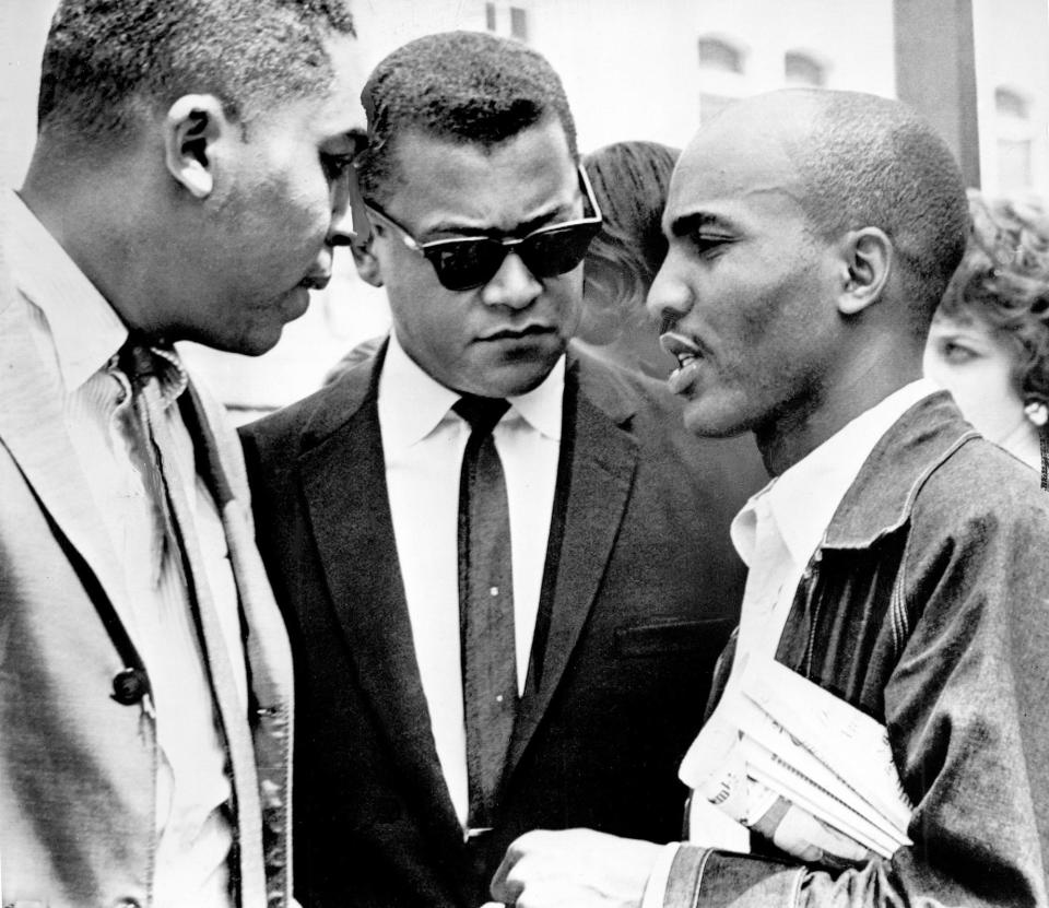 Two leaders of the Nashville desegregation campaign in 1960-61, the Rev. James Lawson of Memphis, center, and the Rev. James Bevel, right, now of Cleveland, Miss., talk on the street during demonstrations in Birmingham, Ala., May 7, 1963.