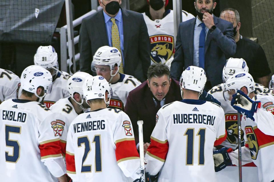 Florida Panthers assistant coach Andrew Brunette, center, talks with players during the third period of an NHL hockey game against the Chicago Blackhawks, Tuesday, March 23, 2021, in Chicago. Brunette spent four years playing for Joel Quenneville, and until Thursday night, Oct. 28, 2021, worked for Joel Quenneville. He's now - at least on an interim basis - taking over for Quenneville, who resigned Thursday night over his role in how the Blackhawks largely ignored a player's sexual assault claims against another coach 11 years ago. (AP Photo/Matt Marton, File)