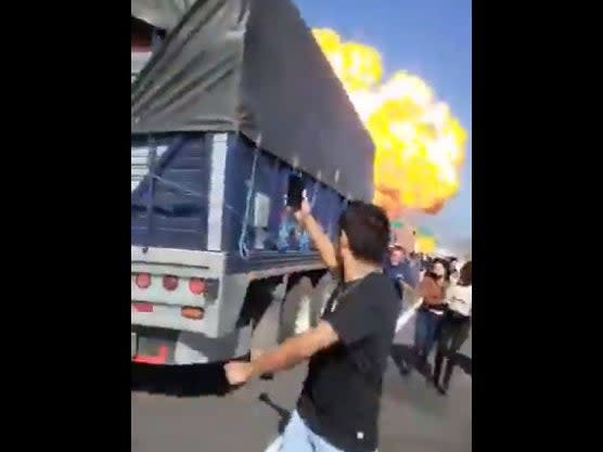 Bystanders flee a gas explosion that rocked a highway in Nayarit, Mexico and left at least 14 dead on Monday.  (Twitter)