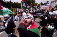 Demonstrators holding signs march to Israeli Consulate during a protest against Israel and in support of Palestinians, Saturday, May 15, 2021 in the Westwood section of Los Angeles. (AP Photo/Ringo H.W. Chiu)