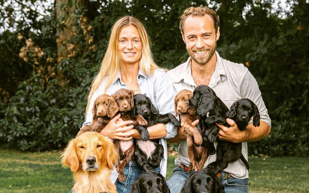 James Middleton and his fiancee Alizee Thevenet with the puppies, one of whom was given to the Cambridges last year