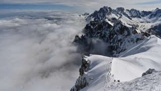 Mountaineers ski to the 'Vallee Blanche' a glacial valley located in the Mont-Blanc massif, from the 'Aiguille du Midi' peak in Chamonix, on May 16, 2020, on the first day of the reopening as France eases lockdown measures taken to curb the spread of the COVID-19 pandemic, caused by the novel coronavirus. (Photo by PHILIPPE DESMAZES / AFP)