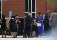 Mourners arrive for the funeral of Kristina Bobbi Brown, the only child of singer Whitney Houston at Saint James United Methodist Church in Alpharetta, Georgia, August 1, 2015. REUTERS/Tami Chappell