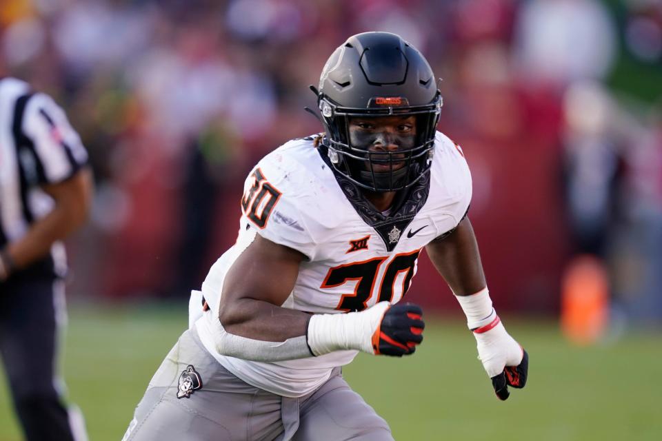 Oklahoma State defensive end Collin Oliver (30) runs on the field during the second half of an NCAA college football game against Iowa State, Saturday, Oct. 23, 2021, in Ames, Iowa. Iowa State won 24-21. (AP Photo/Charlie Neibergall)