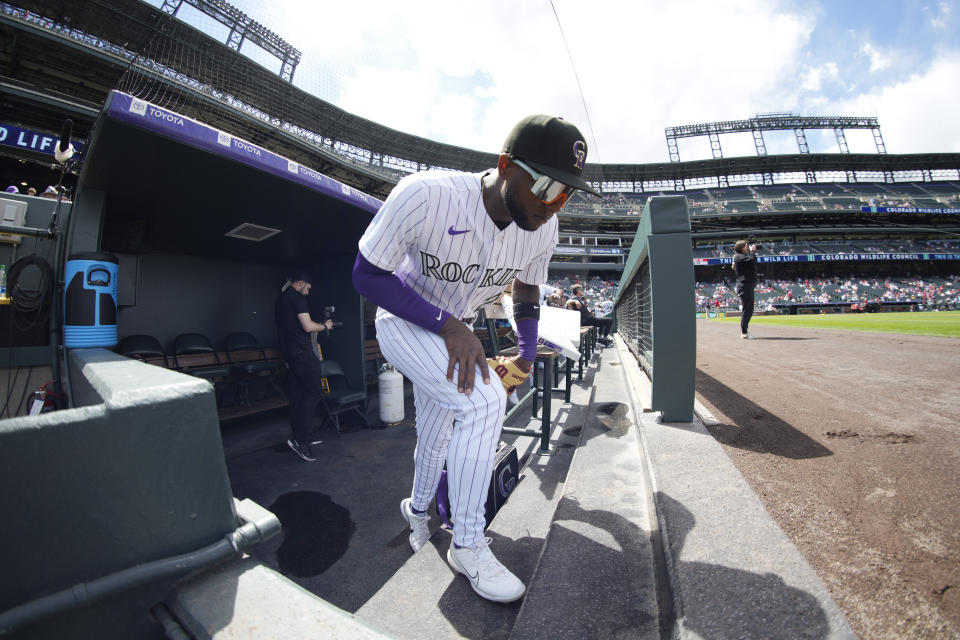Colorado Rockies left fielder Jurickson Profar takes the field to warm up before a baseball game against the St. Louis Cardinals, Wednesday, April 12, 2023, in Denver. (AP Photo/David Zalubowski