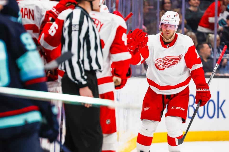 Red Wings right wing Daniel Sprong high-fives teammates on the bench after scoring a goal against the Kraken during the second period on Monday, Feb. 19, 2024, in Seattle.