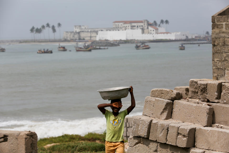 A boy, with Elmina Castle in the background in Elmina, Ghana. (Photo: Siphiwe Sibeko/Reuters)