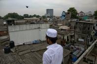 A Muslim volunteer stands in a roof of a mosque to spot possible attackers during Friday prayers in Colombo, Sri Lanka, Friday, April 26, 2019. Religious leaders cancelled large public gatherings amid warnings of more attacks, along with retaliatory sectarian violence in Sri Lanka though some still held communal Friday prayers at mosques. (AP Photo/Gemunu Amarasinghe)