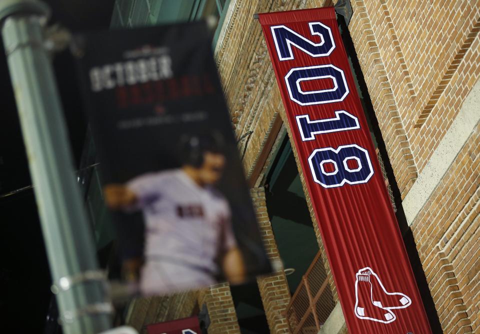 The 2018 World Series baseball championship banner hangs outside Fenway Park in Boston, Monday, Oct. 29, 2018. The Boston Red Sox won the series against the Los Angeles Dodgers on Sunday in Los Angeles. (AP Photo/Michael Dwyer)