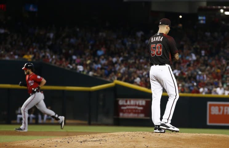 Anthony Banda rubs up a new ball after giving up a home run to Bryce Harper. (AP)