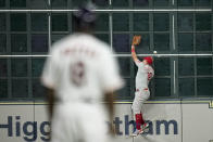 Philadelphia Phillies left fielder Kyle Schwarber can't get a glove on a double by Houston Astros' Alex Bregman during the 10th inning in Game 1 of baseball's World Series between the Houston Astros and the Philadelphia Phillies on Friday, Oct. 28, 2022, in Houston. (AP Photo/Eric Gay)