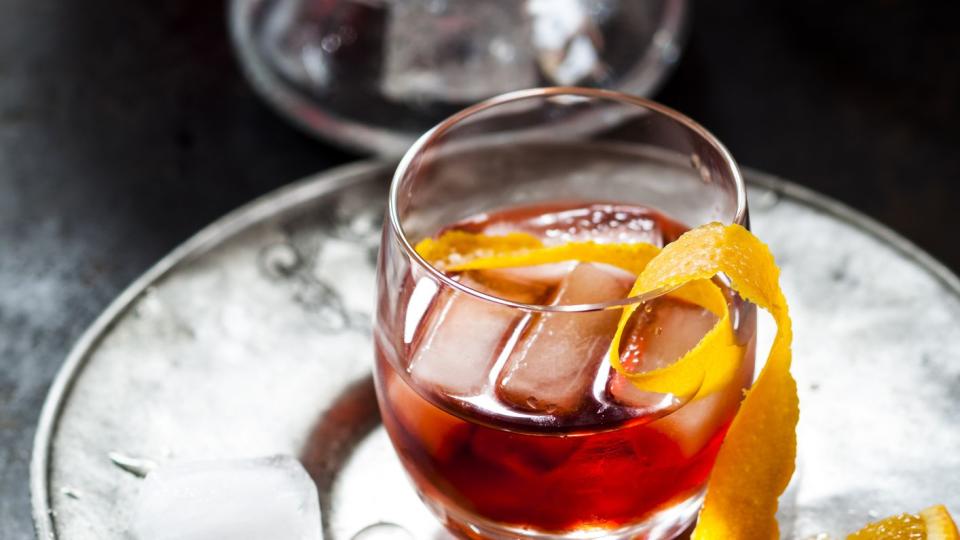 negroni with orange peel and ice cubes