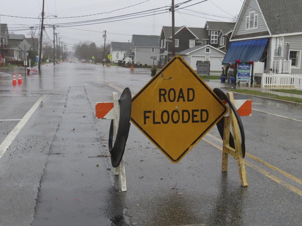 A barrier warns of flooding in Bay Head, N.J. during a storm on Monday, Dec. 18, 2023. Communities up and down the East Cast were dealing with flooding and high winds from the storm. (AP Photo/Wayne Parry)