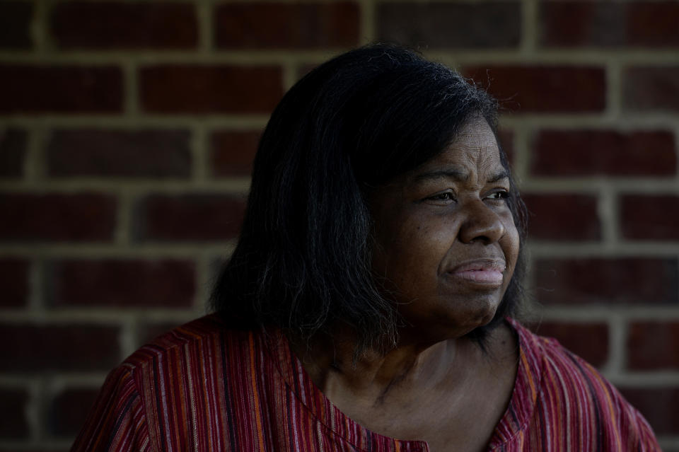 Debra Smith, 57, who has health problems that prevent her from working, sits on her front porch on Thursday, Oct. 7, 2021, in Spring Hill, Tenn. Smith has about $10,000 in unpaid medical bills. (AP Photo/Mark Zaleski)