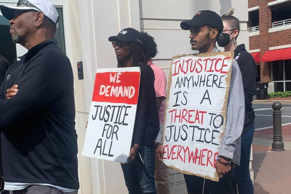 Jaymond Bryant-Herron (right) and others show up outside Concord City Hall in support of the family of Brandon Combs on Tuesday, June 28, 2022.