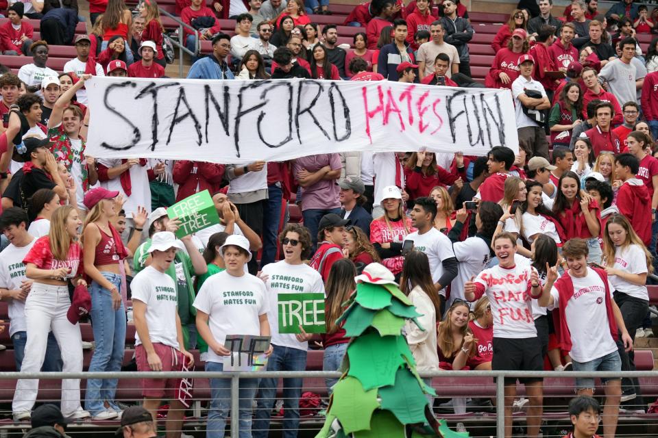 Stanford fans hold up a sign that says "Stanford Hates Fun."