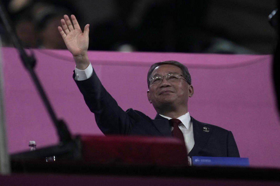 Chinese Premier Li Qiang waves as he attends the closing ceremony of the 19th Asian Games in Hangzhou, China, Sunday, Oct. 8, 2023. (AP Photo/Lee Jin-man)