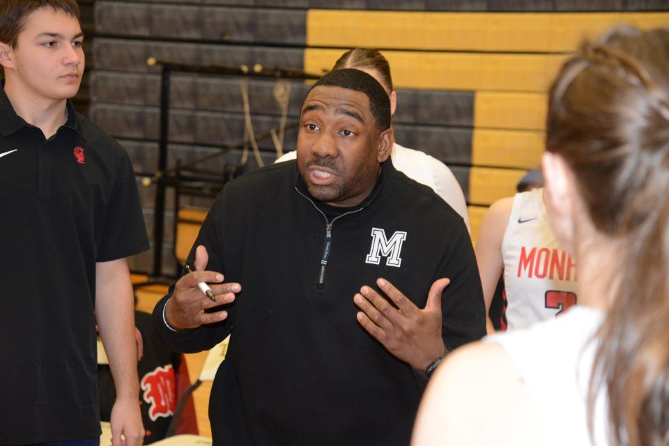 Monore girls basketball coach John Mason makes a point to his players during the semifinals of the Division 1 District at Trenton Wednesday.