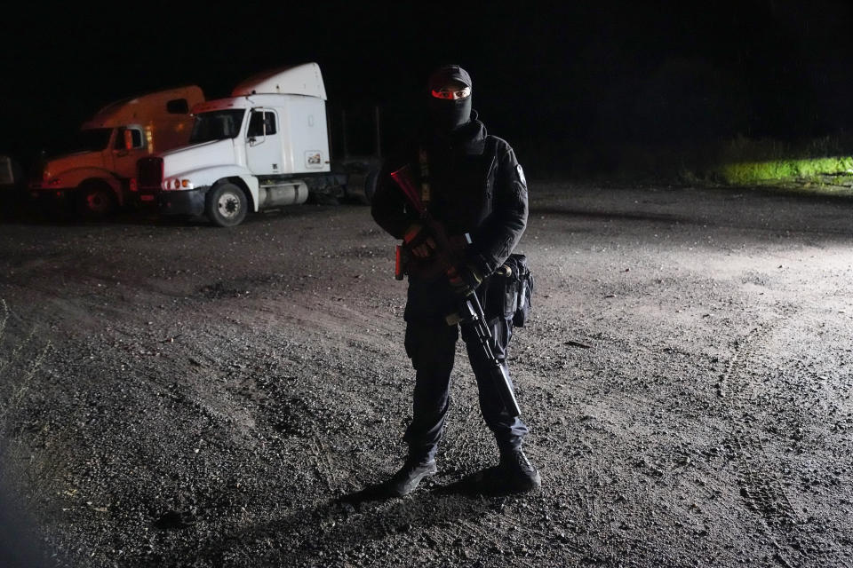 A Russian serviceman guards a road near a private jet crash, near the village of Kuzhenkino, Tver region, Russia, early Thursday, Aug. 24, 2023. Officials say a private jet has crashed over Russia, killing all 10 people on board. Mercenary chief Yevgeny Prigozhin was on the passenger list, and Russia’s civil aviation agency says he was on board. (AP Photo/Alexander Zemlianichenko)