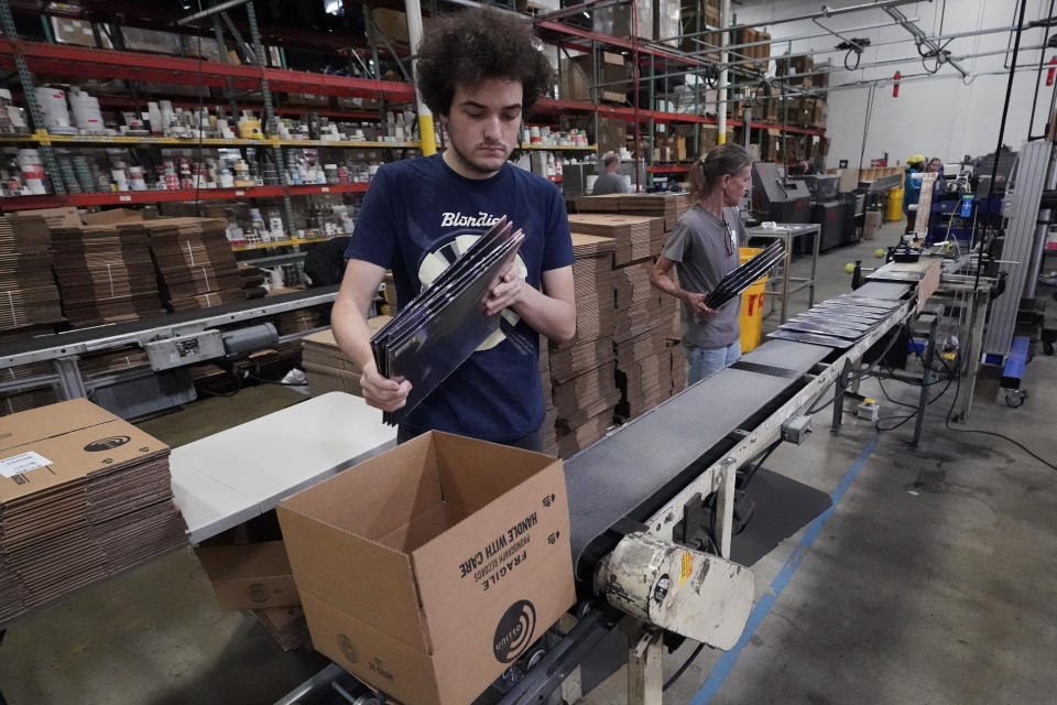 Elijah Lindsay loads finished vinyl records into shipping boxes at the United Record Pressing facility Thursday, June 23, 2022, in Nashville, Tenn. Vinyl record manufacturers are rapidly rebuilding an industry to keep pace with sales that topped $1 billion last year. (AP Photo/Mark Humphrey)