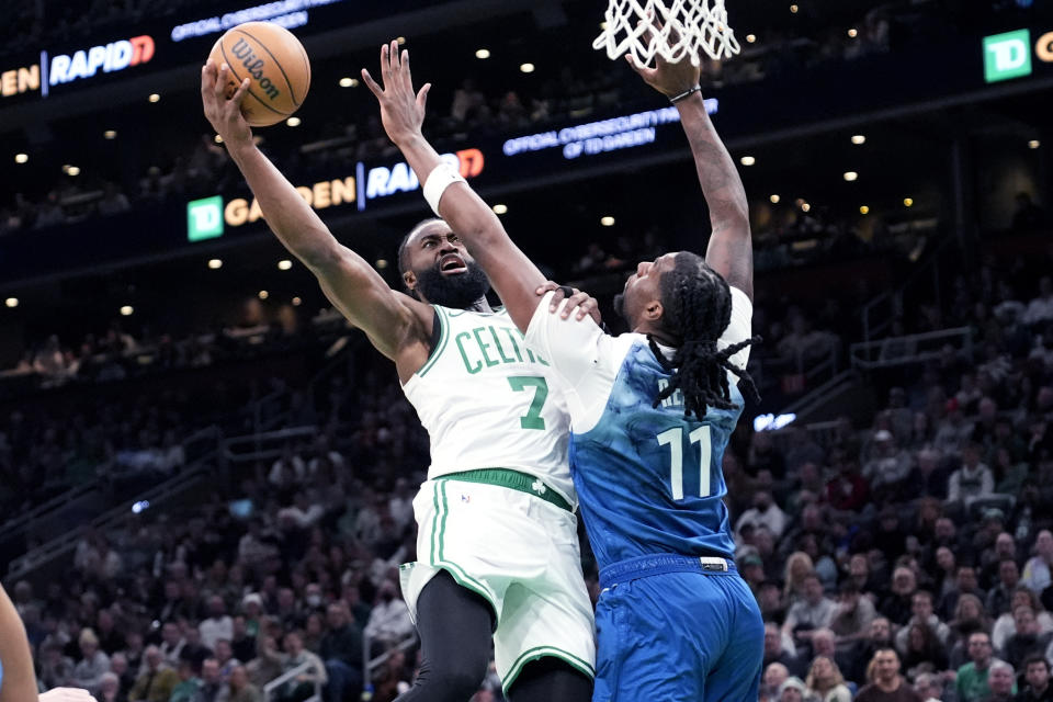 Boston Celtics guard Jaylen Brown (7) drives to the basket against Minnesota Timberwolves center Naz Reid (11) during the first half of an NBA basketball game Wednesday, Jan. 10, 2024, in Boston. (AP Photo/Charles Krupa)