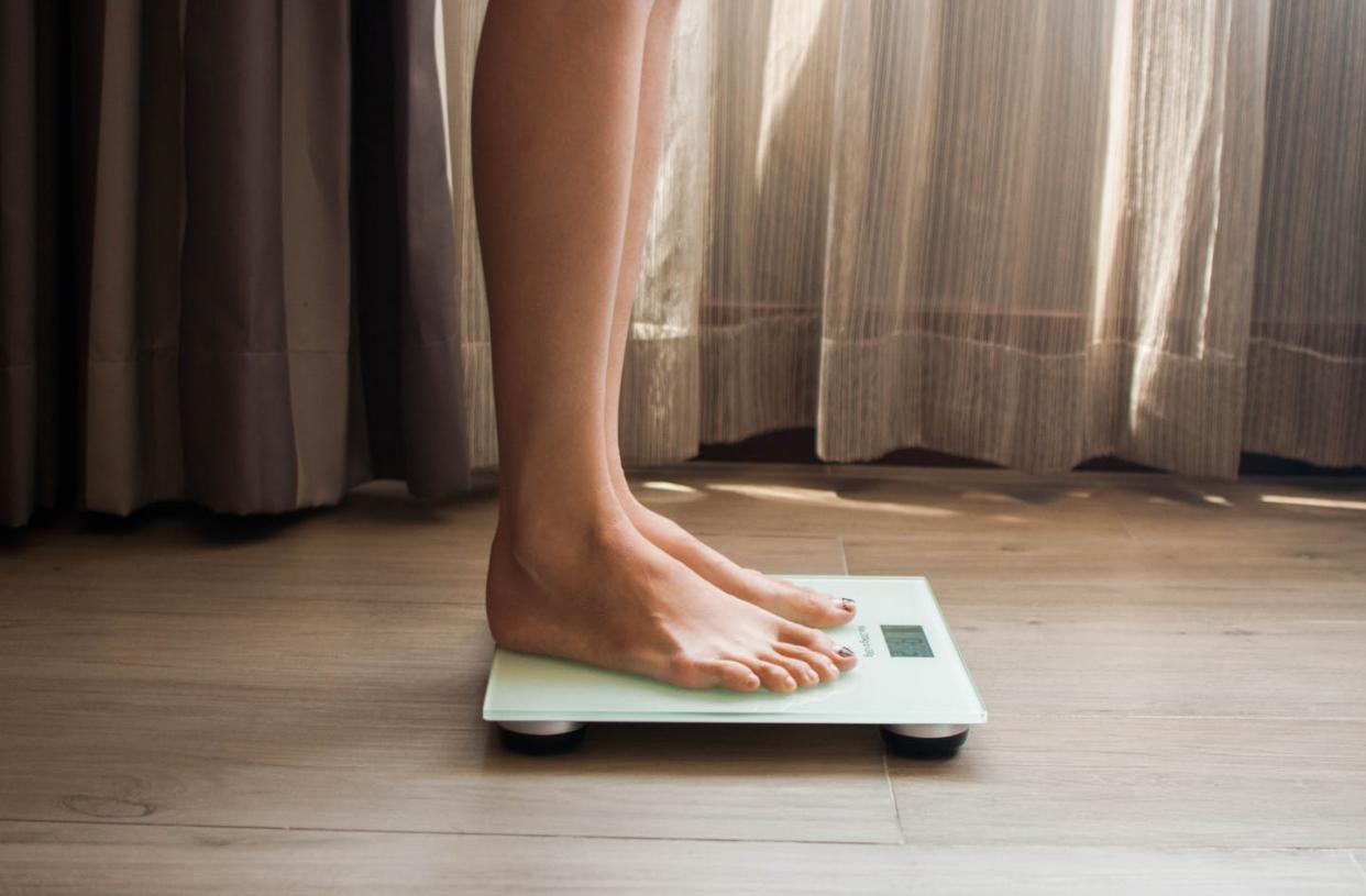 <span class="caption">Stress hormones are closely tied to hunger and motivation.</span> <span class="attribution"><a class="link " href="https://www.gettyimages.com/detail/photo/young-woman-is-weighing-herself-in-a-weighing-scale-royalty-free-image/1139272587?adppopup=true" rel="nofollow noopener" target="_blank" data-ylk="slk:Karl Tapales/Moment via Getty Images;elm:context_link;itc:0;sec:content-canvas">Karl Tapales/Moment via Getty Images</a></span>