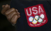 Benn Fields holds the sweatshirt he received as a member of the 1980 U.S. Olympic team, Friday, July 31, 2020, at his home in Salisbury Mills, N.Y. He won the Olympic trials in 1980 and was ranked No. 1 in the U.S. that summer. (AP Photo/Mark Lennihan)