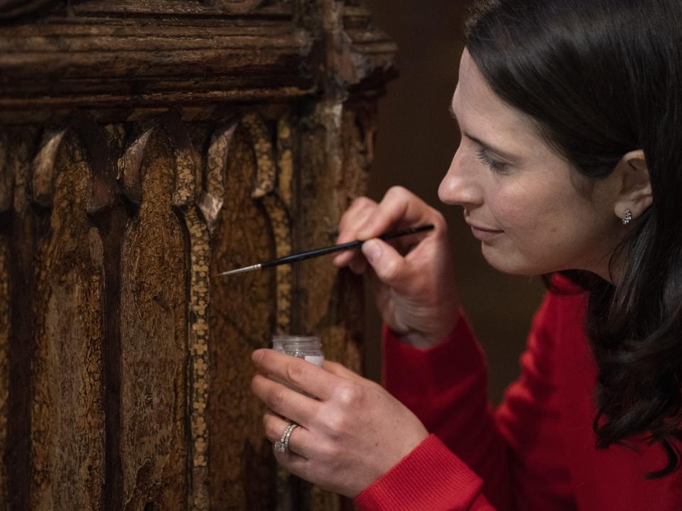 Conservator Krista Blessley works on the restoration of a Coronation chair on February 28, 2023 at Westminster Abbey in London.