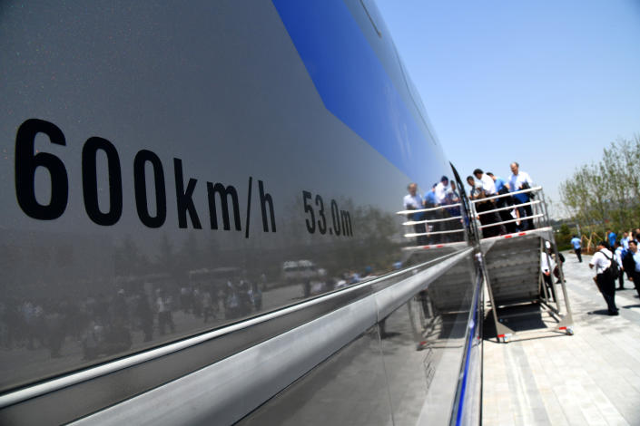 QINGDAO, May 23, 2019 -- Guests visit China's first high-speed maglev train testing prototype in Qingdao, east China's Shandong Province,on May 23, 2019. China on Thursday rolled off the production line a prototype magnetic-levitation train with a designed top speed of 600 km per hour in the eastern city of Qingdao.     The debut of China's first high-speed maglev train testing prototype marks a major breakthrough for the country in the high-speed maglev transit system.     The engineering prototype is scheduled to roll off the production line in 2020 and go through comprehensive tests to finish integrated verification in 2021. (Xinhua/Li Ziheng) (Xinhua/ via Getty Images)
