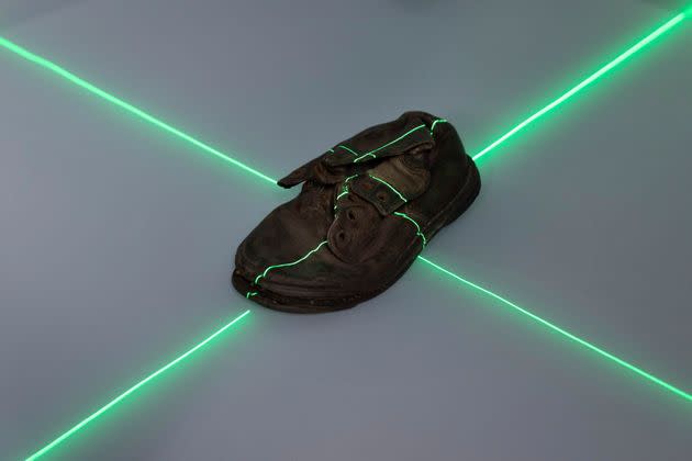 A shoe that belonged to a child victim of the former Nazi German death camp Auschwitz-Birkenau is scanned at the conservation laboratory on the grounds of the camp in Oswiecim, Poland.