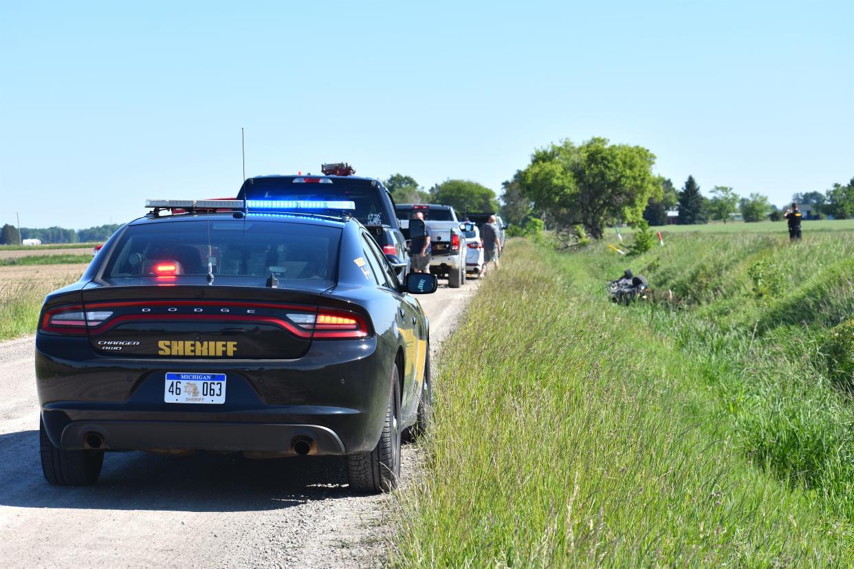 A Lenawee County Sheriff's Office patrol car and other emergency vehicles line Lipp Highway in Riga Township May 30, 2021, while responding to a single-vehicle crash that killed a 78-year-old passenger from Blissfield and sent the 48-year-old driver, also from Blissfield, to the hospital. Deputies reported the driver lost control of the car on the gravel roadway, causing it to go off the road and into a large ditch.