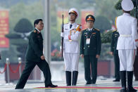 Vietnam's Defense Minister Ngo Xuan Lich, left, arrives for the opening ceremony of the 13th National Congress of Vietnam's Communist Party (VCP), in Hanoi, Vietnam, Tuesday, Jan. 26, 2021. (AP Photo/Minh Hoang)