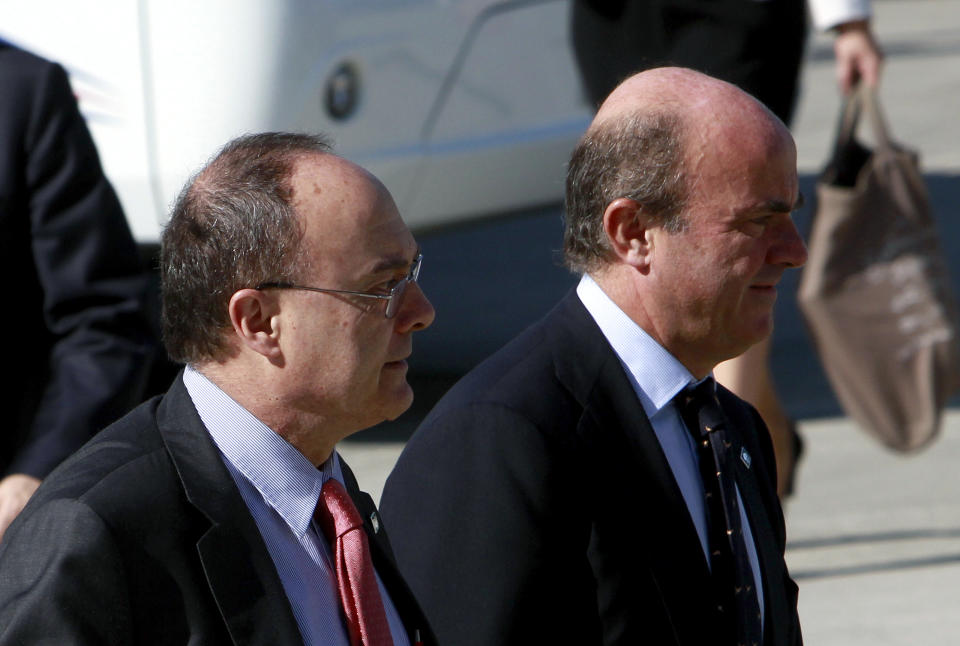 Spain's financial Minister Luis de Guindos, right, with Governor Central Bank of Spain Luis Linde arrive at the conference center in Nicosia, Cyprus, Saturday, Sept. 15, 2012. The creation of a banking union will top the agenda at an informal meeting of European finance ministers in the Cypriot capital. (AP Photo/Petros Karadjias)