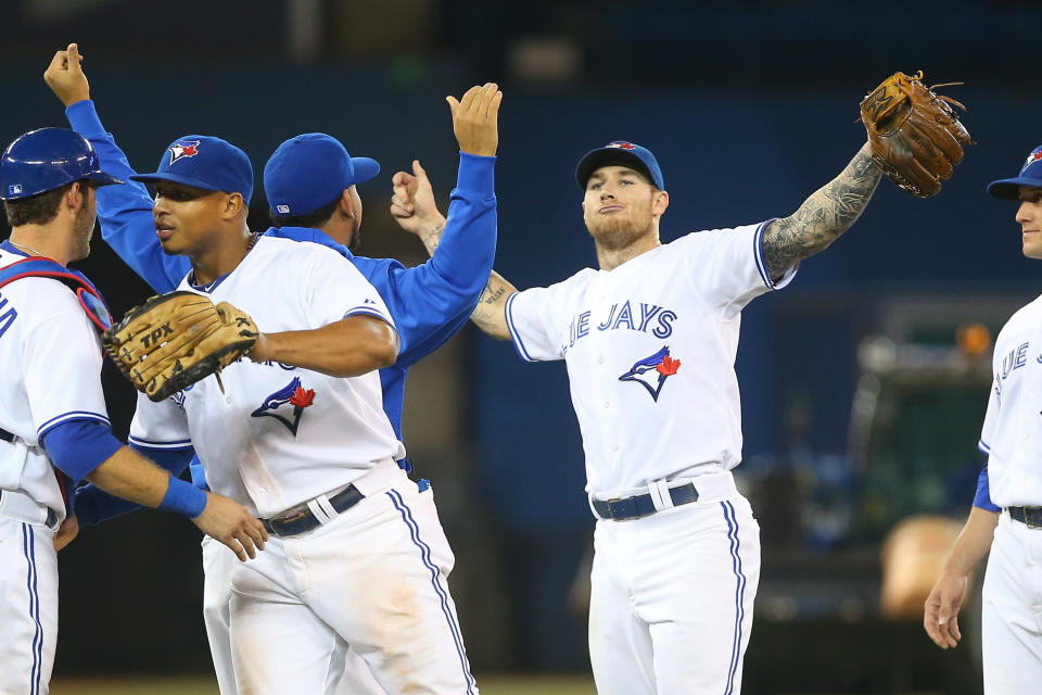 TORONTO, CANADA - OCTOBER 3: Brett Lawrie #17 of the Toronto Blue Jays celebrates with teammates after defeating the Minnesota Twins in MLB game action on October 3, 2012 at Rogers Centre in Toronto, Ontario, Canada. (Photo by Tom Szczerbowski/Getty Images)