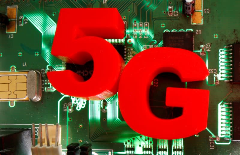 FILE PHOTO: 3D-printed objects representing 5G are put on a motherboard in this picture illustration