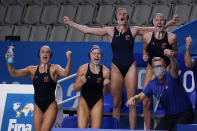 United States players and coaches celebrate a goal during a win against the Russian Olympic Committee in a semifinal round women's water polo match at the 2020 Summer Olympics, Thursday, Aug. 5, 2021, in Tokyo, Japan. (AP Photo/Mark Humphrey)