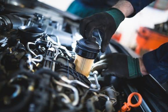 Mechanic changing filter of a car